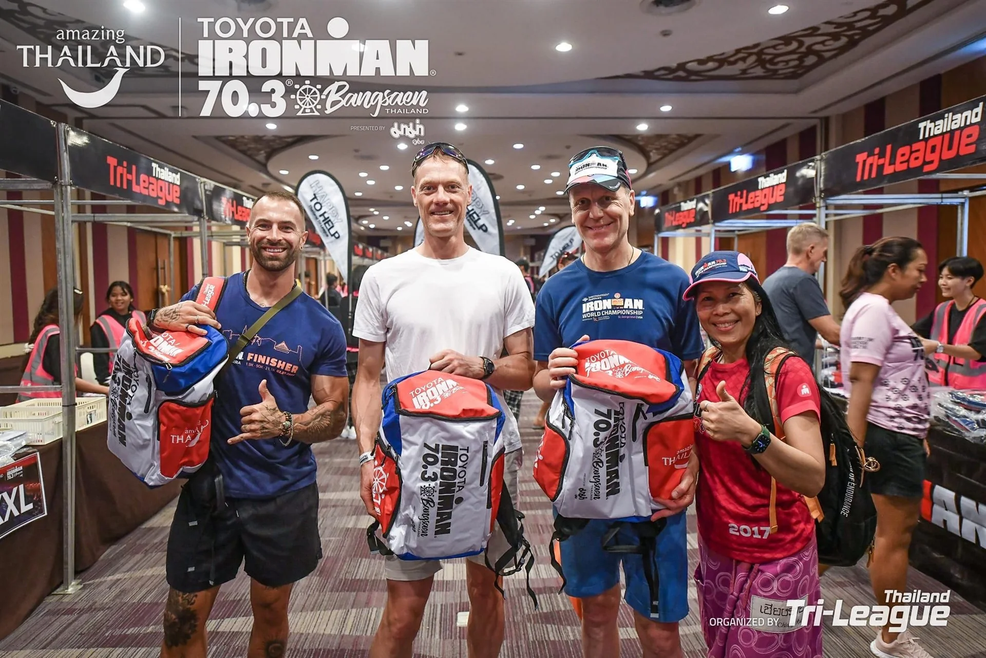 Race participants holding custom backpacks at the Bangsaen event expo