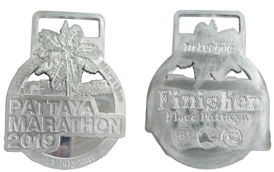 Supplied photograph of the front and back of the Pattaya Marathon metal sample