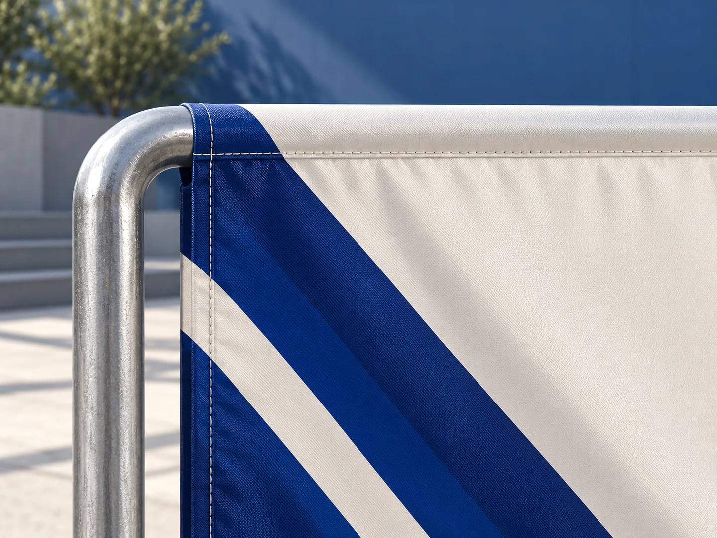 Product design concept close-up of the blue and ivory barrier cover edge and silver tubular frame