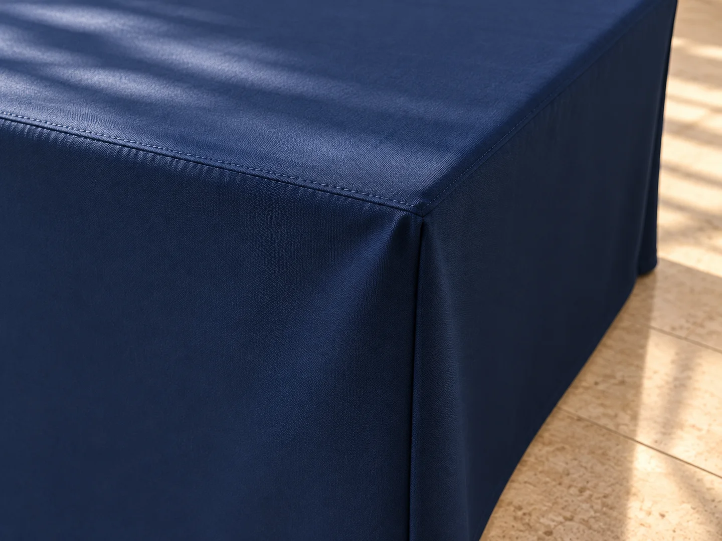 Product design concept close-up of the navy tablecloth corner, seam and natural drape